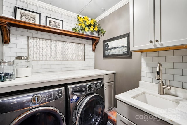 229 N Church St Unit 401, Charlotte, NC 28202 - washroom with independent washer and dryer, cabinet space, and ornamental molding