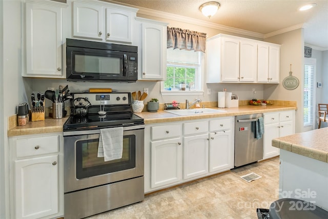 1828 Pine Hollow Pl, Hudson, NC 28638 - kitchen with stainless steel appliances, crown molding, white cabinets, and plenty of natural light