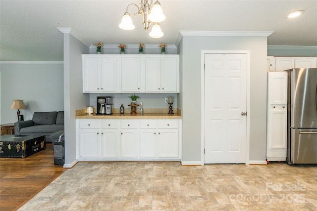 1828 Pine Hollow Pl, Hudson, NC 28638 - kitchen featuring freestanding refrigerator, crown molding, white cabinetry, light countertops, and a chandelier