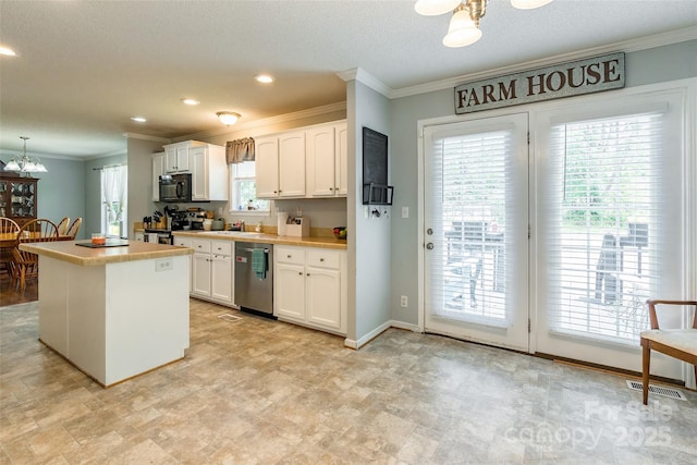 1828 Pine Hollow Pl, Hudson, NC 28638 - kitchen with appliances with stainless steel finishes, ornamental molding, a chandelier, white cabinetry, and a kitchen island