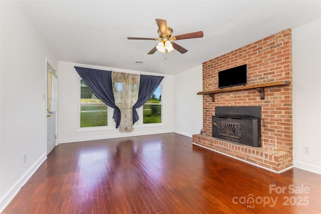 416 Pete Brittain Rd, Morganton, NC 28655 - unfurnished living room with plenty of natural light, wood finished floors, a ceiling fan, and a brick fireplace