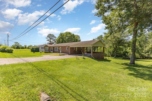416 Pete Brittain Rd, Morganton, NC 28655 - view of front of home featuring asphalt driveway, a front lawn, an attached carport, and a chimney