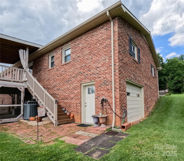 2963 Freezer Locker Rd, Hudson, NC 28638 - rear view of house featuring a garage, a yard, stairway, and brick siding