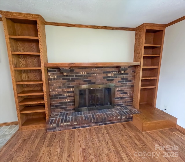 2963 Freezer Locker Rd, Hudson, NC 28638 - unfurnished living room featuring a brick fireplace, wood finished floors, and crown molding