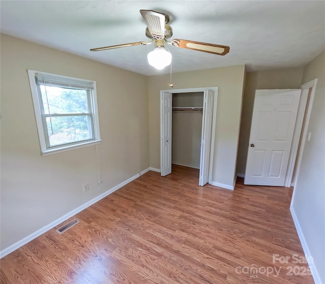 2963 Freezer Locker Rd, Hudson, NC 28638 - unfurnished bedroom featuring light wood-style flooring, a closet, and a ceiling fan