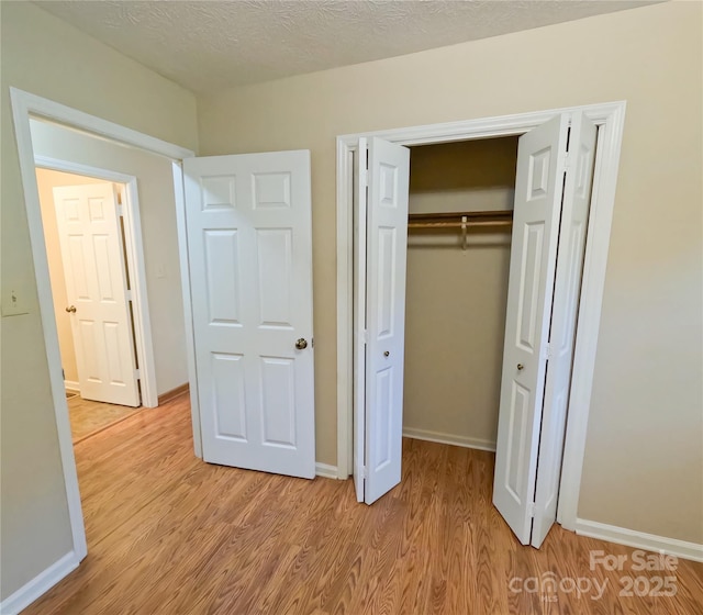 2963 Freezer Locker Rd, Hudson, NC 28638 - unfurnished bedroom with light wood-style flooring and a closet