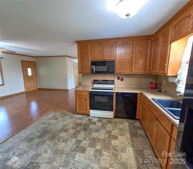 2963 Freezer Locker Rd, Hudson, NC 28638 - kitchen with black appliances, brown cabinets, light countertops, open floor plan, and crown molding