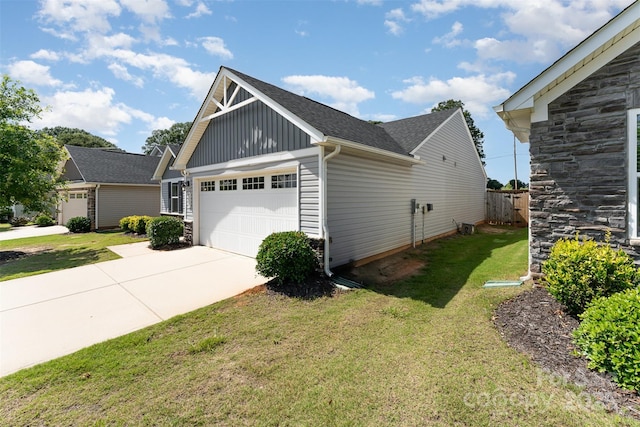 4227 Mackinnon Dr, Charlotte, NC 28214 - view of property exterior featuring board and batten siding, a garage, stone siding, and driveway