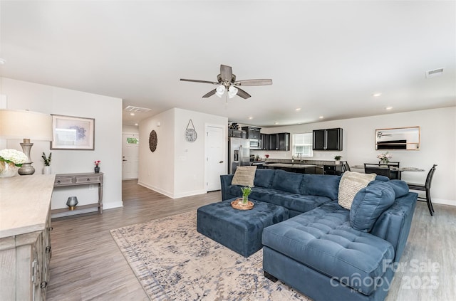 4227 Mackinnon Dr, Charlotte, NC 28214 - living area with light wood-style flooring, a ceiling fan, and recessed lighting