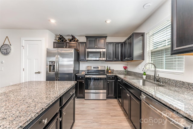 4227 Mackinnon Dr, Charlotte, NC 28214 - kitchen with appliances with stainless steel finishes, light wood-style flooring, light stone counters, and recessed lighting