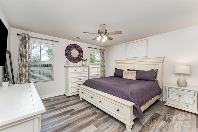4227 Mackinnon Dr, Charlotte, NC 28214 - bedroom with wood finished floors, multiple windows, and ceiling fan