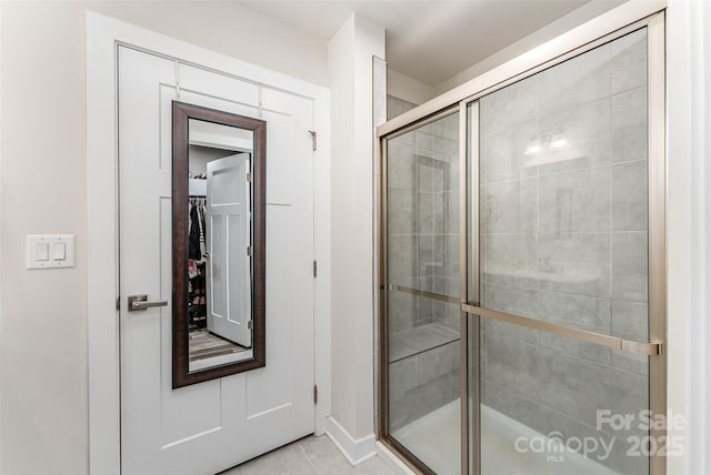 4227 Mackinnon Dr, Charlotte, NC 28214 - full bathroom with a stall shower, a spacious closet, and tile patterned floors