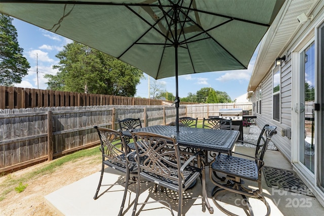 4227 Mackinnon Dr, Charlotte, NC 28214 - fenced backyard with outdoor dining area and a patio area