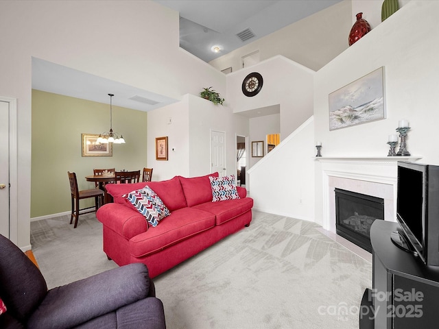 12415 Stratfield Place Cir, Pineville, NC 28134 - carpeted living area featuring high vaulted ceiling, a chandelier, and a glass covered fireplace