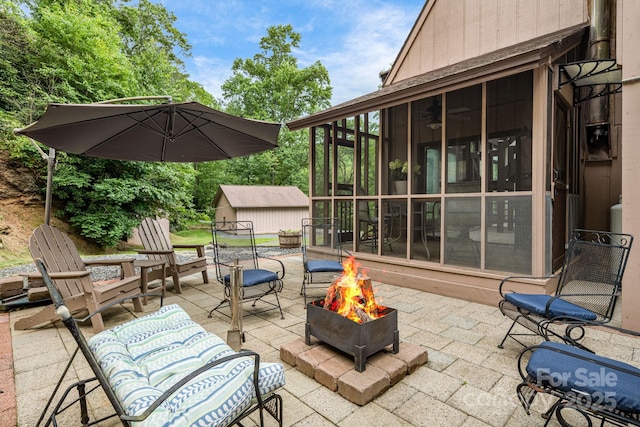 79 Creekside Ln, Spruce Pine, NC 28777 - view of patio featuring an outdoor fire pit, a sunroom, and a shed