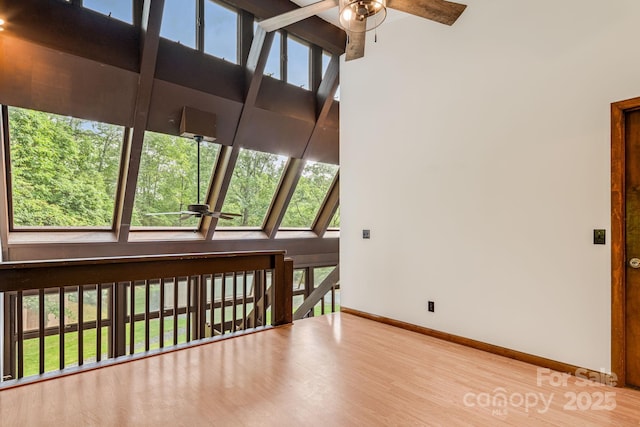 79 Creekside Ln, Spruce Pine, NC 28777 - spare room featuring a ceiling fan, wood finished floors, a high ceiling, and a skylight