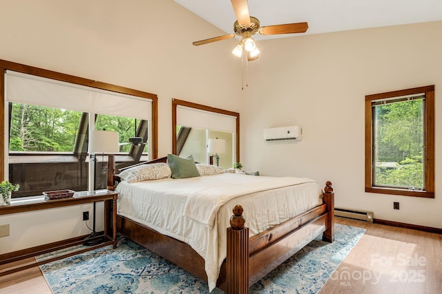 79 Creekside Ln, Spruce Pine, NC 28777 - bedroom featuring a baseboard radiator, wood finished floors, a wall mounted air conditioner, and ceiling fan