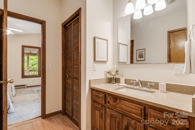 79 Creekside Ln, Spruce Pine, NC 28777 - bathroom featuring vanity, wood finished floors, a closet, and a baseboard radiator