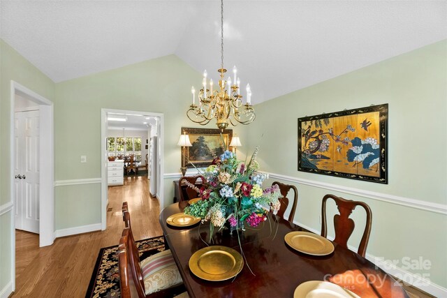600 Queens Rd, Cherryville, NC 28021 - dining area featuring a chandelier, wood finished floors, and vaulted ceiling