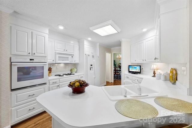 600 Queens Rd, Cherryville, NC 28021 - kitchen with white appliances, light countertops, white cabinets, backsplash, and crown molding