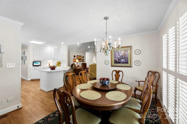 600 Queens Rd, Cherryville, NC 28021 - dining area featuring wallpapered walls, light wood-style flooring, a chandelier, and ornamental molding