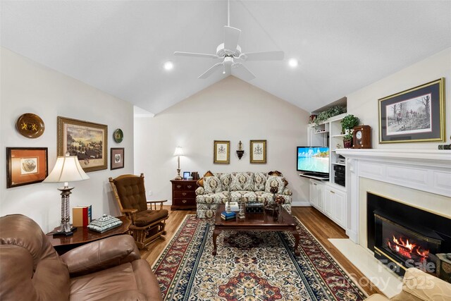 600 Queens Rd, Cherryville, NC 28021 - living area with a fireplace with flush hearth, ceiling fan, wood finished floors, lofted ceiling, and recessed lighting