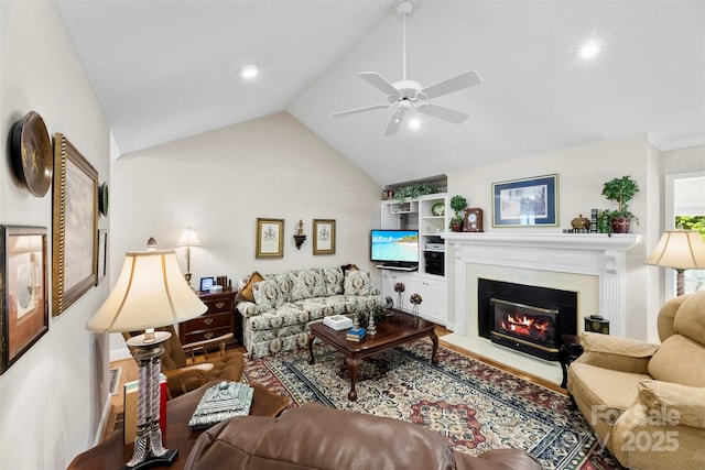 600 Queens Rd, Cherryville, NC 28021 - living room featuring lofted ceiling, a glass covered fireplace, wood finished floors, and a ceiling fan