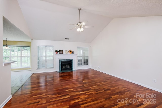 6414 Goldenblush Cir, Charlotte, NC 28269 - unfurnished living room with wood finished floors, ceiling fan, a fireplace with flush hearth, and high vaulted ceiling