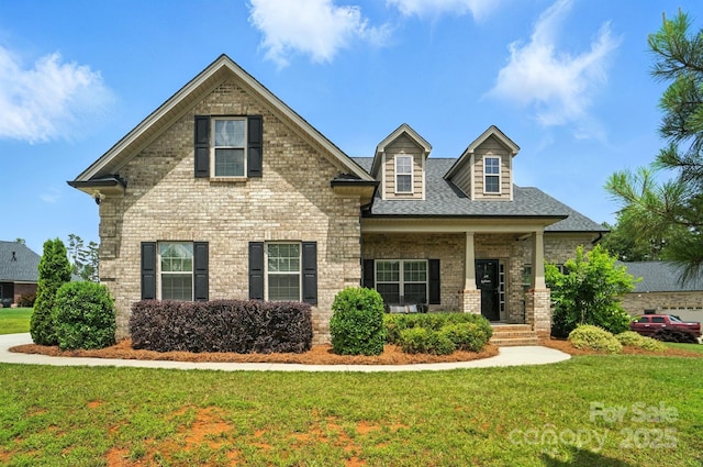3256 Fairmead Dr, Concord, NC 28025 - view of front facade featuring a front yard, brick siding, covered porch, and a shingled roof