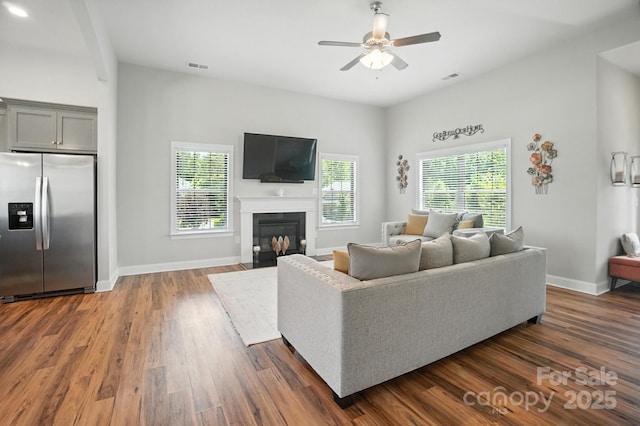 3256 Fairmead Dr, Concord, NC 28025 - living area featuring plenty of natural light, ceiling fan, dark wood-style flooring, and a fireplace with flush hearth