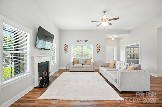 3256 Fairmead Dr, Concord, NC 28025 - living area with ceiling fan, dark wood-style flooring, and a fireplace with flush hearth