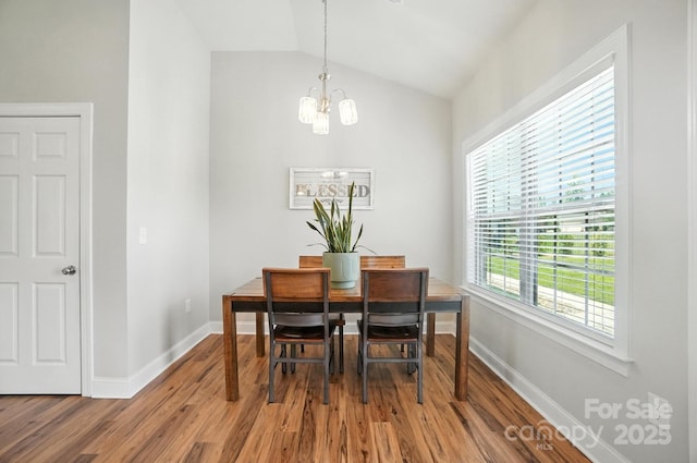 3256 Fairmead Dr, Concord, NC 28025 - dining area featuring a chandelier, wood finished floors, and lofted ceiling