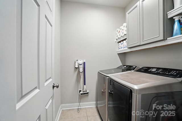 3256 Fairmead Dr, Concord, NC 28025 - laundry area featuring independent washer and dryer, cabinet space, and light tile patterned flooring