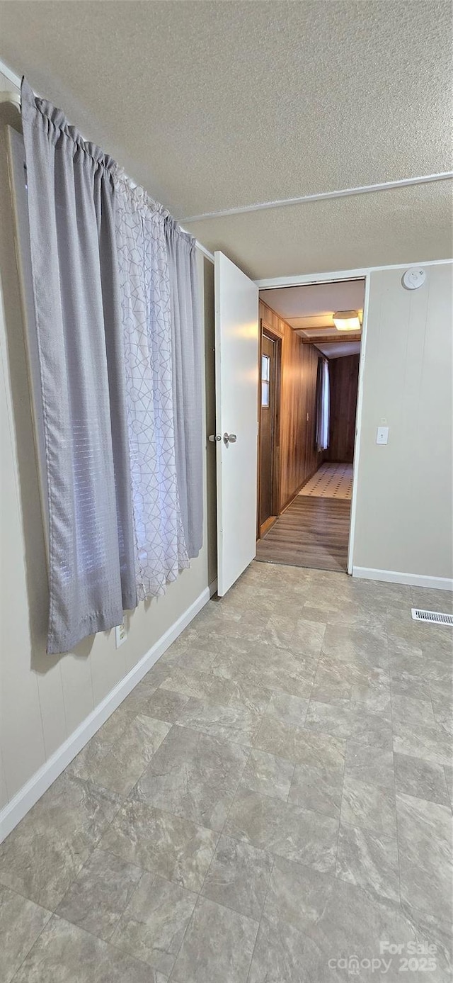 3682 Old Petra Mill Rd, Granite Falls, NC 28630 - unfurnished room featuring a textured ceiling and wood walls