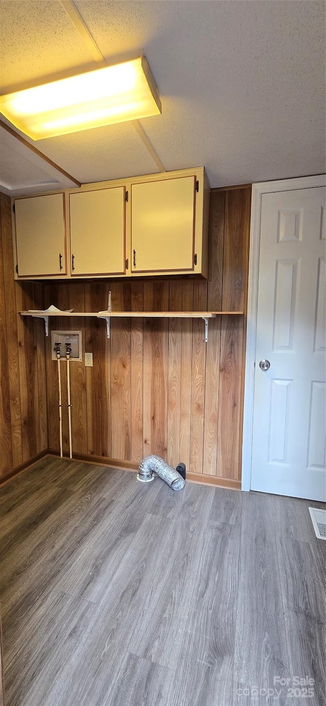 3682 Old Petra Mill Rd, Granite Falls, NC 28630 - laundry room with cabinet space, wood finished floors, wood walls, and washer hookup