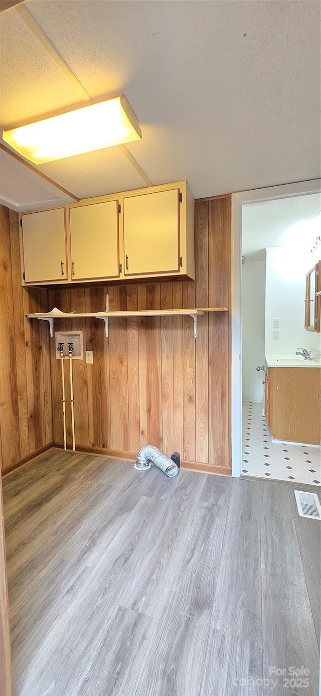 3682 Old Petra Mill Rd, Granite Falls, NC 28630 - washroom featuring cabinet space, wood finished floors, and wood walls