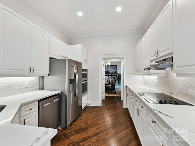 19205 Hidden Cove Ln, Cornelius, NC 28031 - kitchen with under cabinet range hood, appliances with stainless steel finishes, ornamental molding, white cabinetry, and recessed lighting