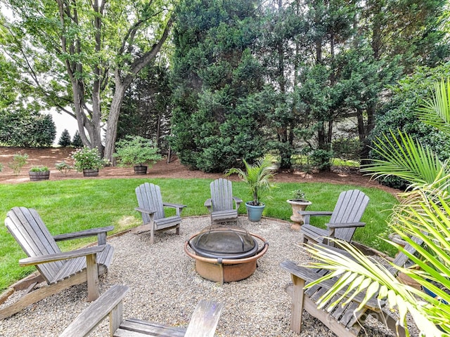 19205 Hidden Cove Ln, Cornelius, NC 28031 - view of grassy yard with an outdoor fire pit and a patio area