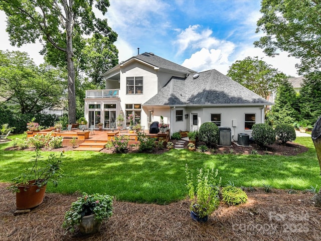 19205 Hidden Cove Ln, Cornelius, NC 28031 - rear view of house featuring a balcony, stucco siding, a shingled roof, a wooden deck, and a lawn