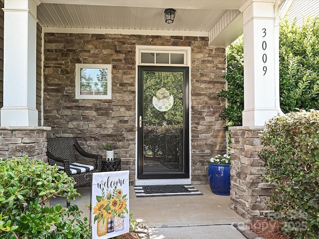 3009 Canopy Dr, Indian Trail, NC 28079 - doorway to property featuring stone siding and covered porch