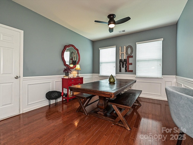 3009 Canopy Dr, Indian Trail, NC 28079 - dining room with a wainscoted wall, dark wood-type flooring, a ceiling fan, and a decorative wall