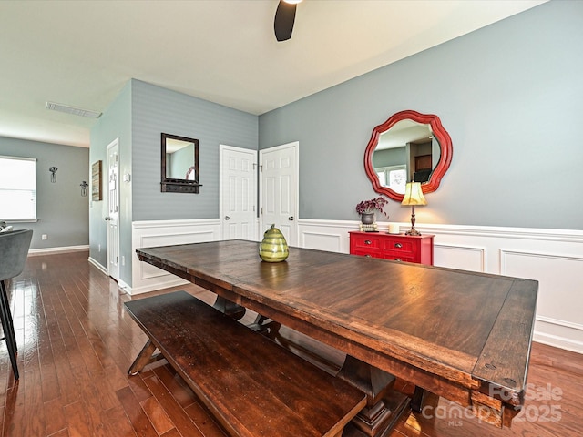 3009 Canopy Dr, Indian Trail, NC 28079 - dining room with ceiling fan, dark wood-type flooring, a wainscoted wall, and a decorative wall
