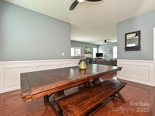 3009 Canopy Dr, Indian Trail, NC 28079 - dining space featuring ceiling fan, a decorative wall, dark wood finished floors, and a wainscoted wall