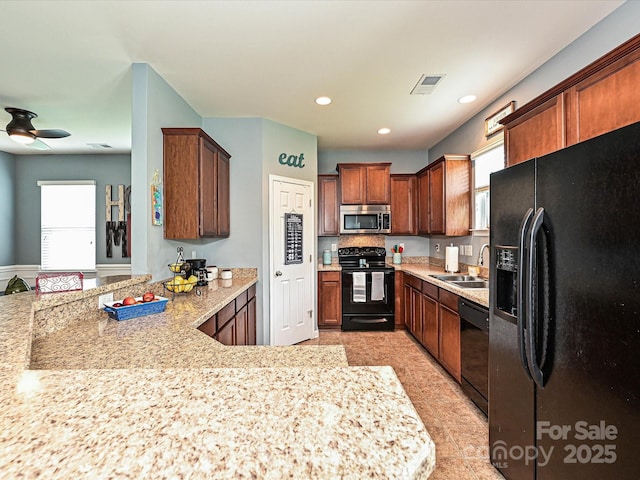 3009 Canopy Dr, Indian Trail, NC 28079 - kitchen featuring black appliances, healthy amount of natural light, a peninsula, ceiling fan, and recessed lighting