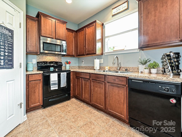 3009 Canopy Dr, Indian Trail, NC 28079 - kitchen with black appliances, light tile patterned floors, light stone countertops, and recessed lighting