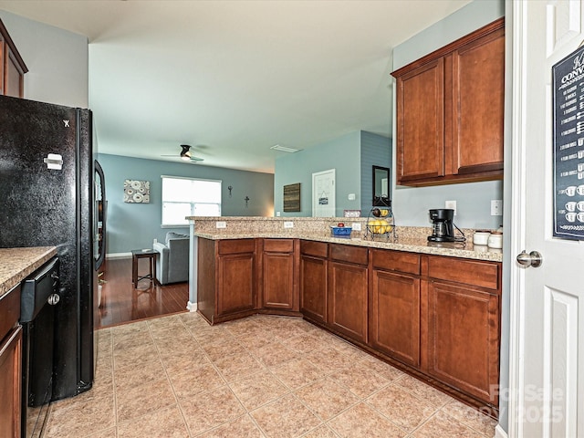 3009 Canopy Dr, Indian Trail, NC 28079 - kitchen featuring black appliances, a peninsula, light stone counters, light tile patterned floors, and ceiling fan
