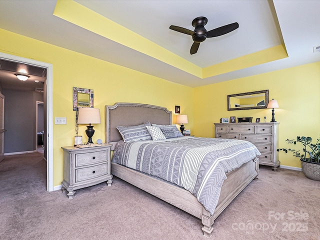 3009 Canopy Dr, Indian Trail, NC 28079 - carpeted bedroom featuring a tray ceiling and a ceiling fan