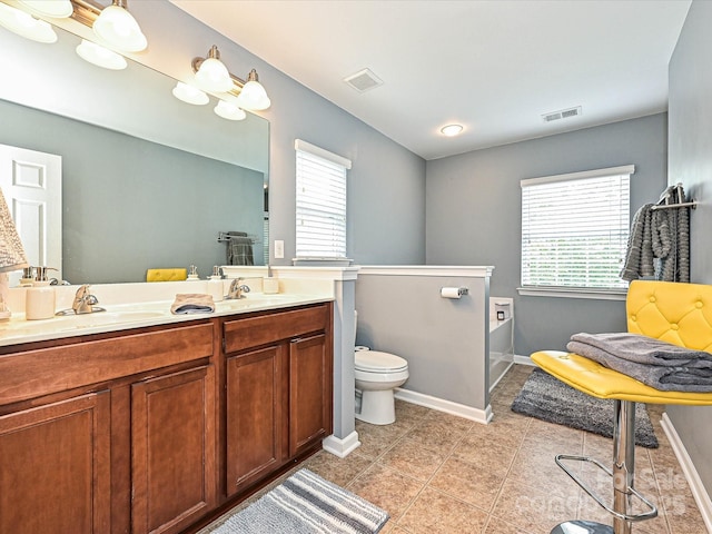 3009 Canopy Dr, Indian Trail, NC 28079 - full bathroom featuring double vanity, plenty of natural light, tile patterned flooring, and a tub to relax in
