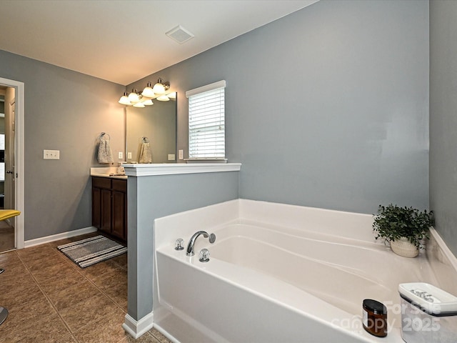 3009 Canopy Dr, Indian Trail, NC 28079 - bathroom featuring vanity, a garden tub, and tile patterned floors
