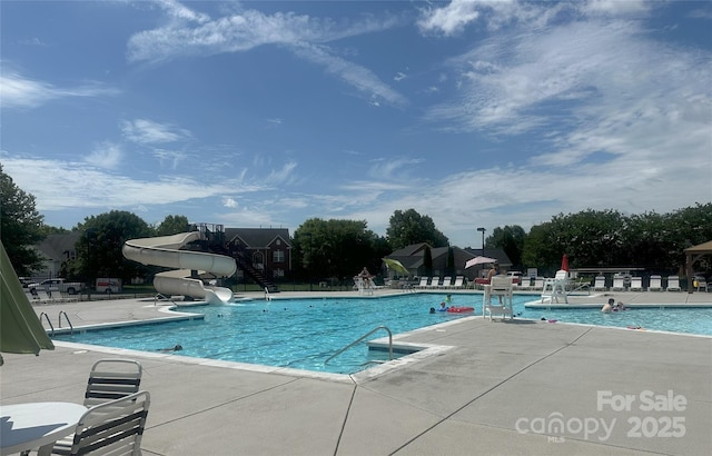 3009 Canopy Dr, Indian Trail, NC 28079 - community pool with a water slide, a patio area, and stairs